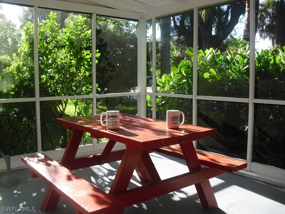 15107 Captiva Drive Captiva, FL 33924 - Photo 14 of 35 a view of a chair and tables in the patio