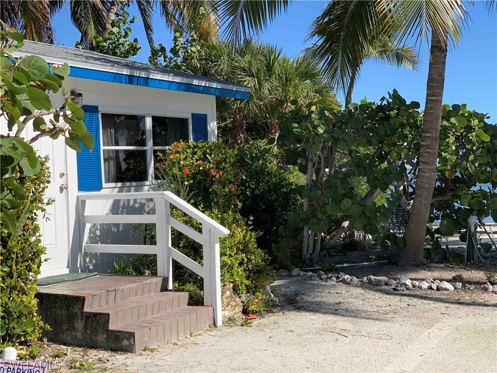 15107 Captiva Drive Captiva, FL 33924 - Photo 15 of 35 front view of house with a yard and potted plants
