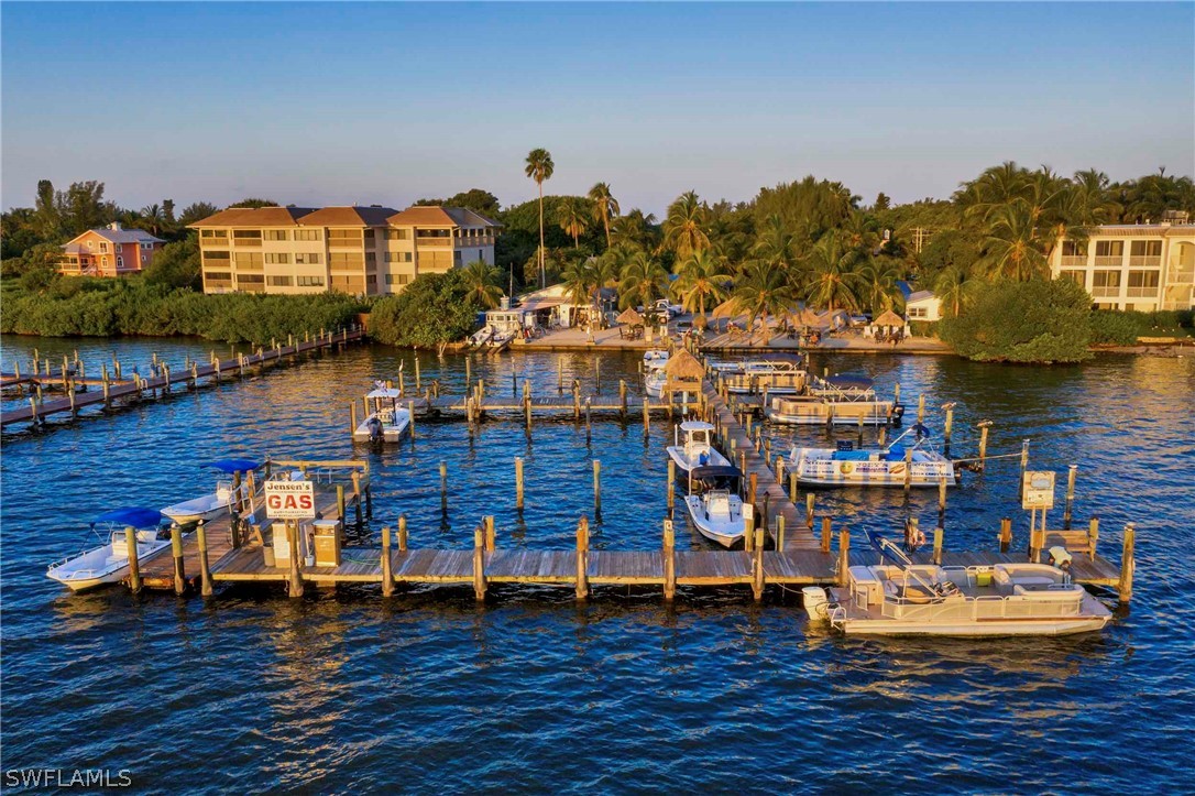 15107 Captiva Drive Captiva, FL 33924 - Photo 26 of 35 a living room with lots of furniture and a wooden floor