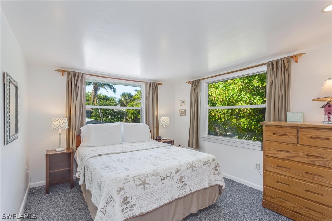 15107 Captiva Drive Captiva, FL 33924 - Photo 29 of 35 a bedroom with a bed and a window