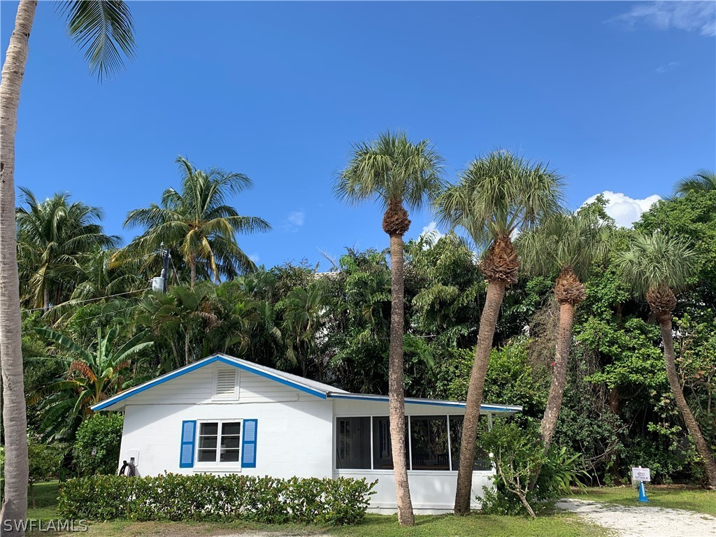 15107 Captiva Drive Captiva, FL 33924 - Photo 31 of 35 a front view of a house with a yard