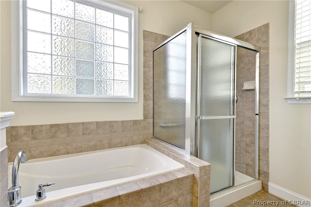 4244 Old Lock Road Williamsburg, VA 23188 - Photo 18 of 31 The primary bath includes a soaking tub and step-in shower.