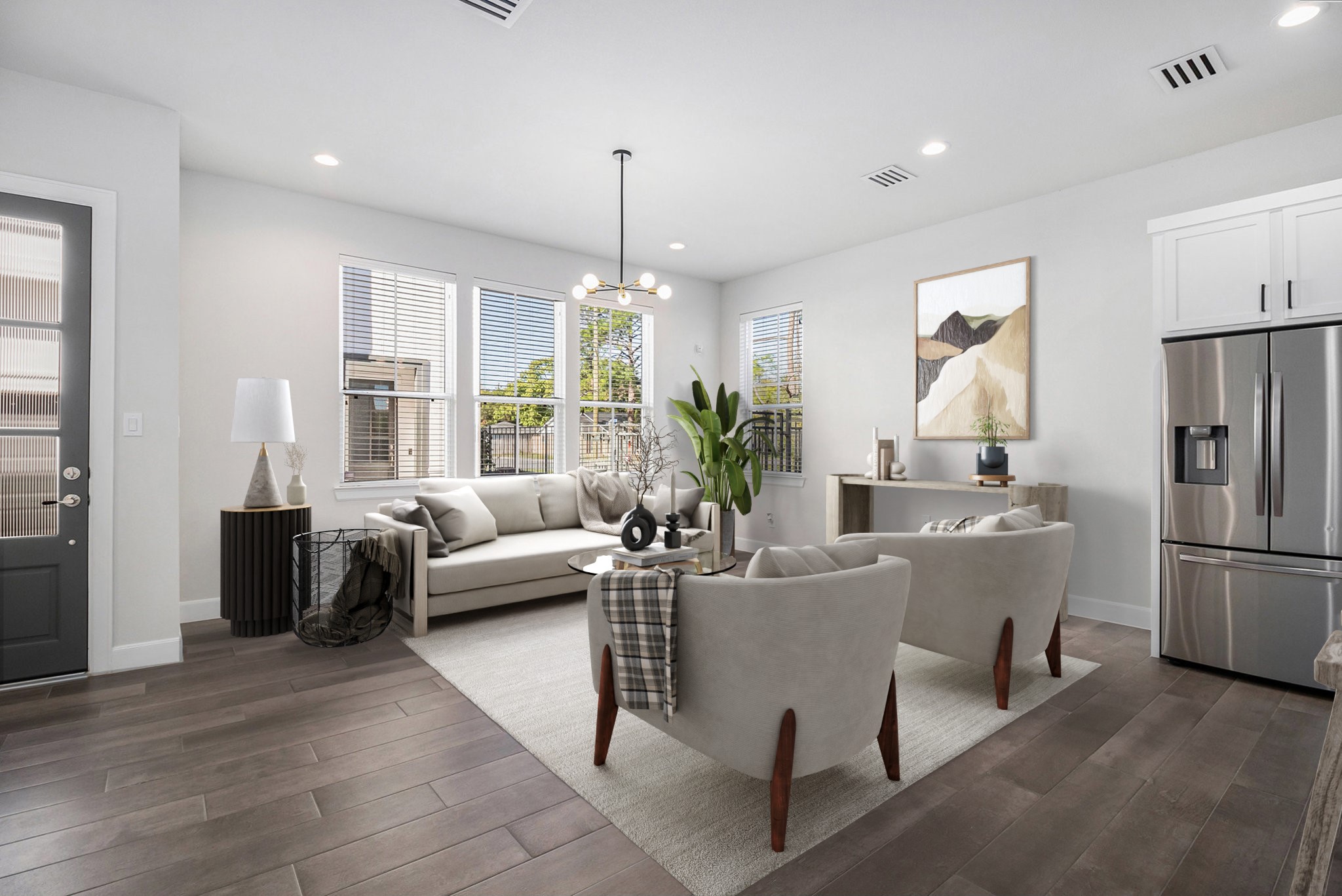 a living room with furniture a large window and a chandelier