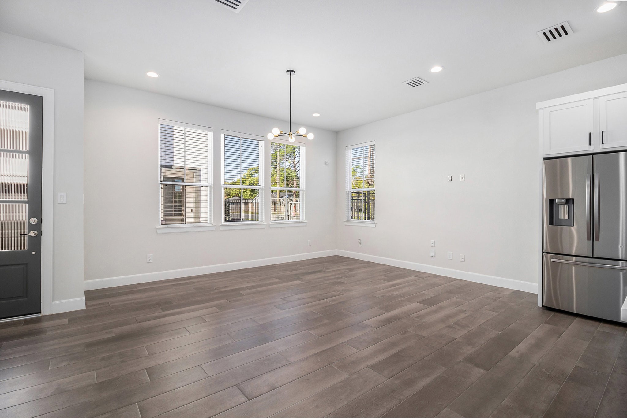 9573 Neuens Road, Unit A Houston, TX 77080 - Photo 2 of 22 a view of an empty room with window and wooden floor