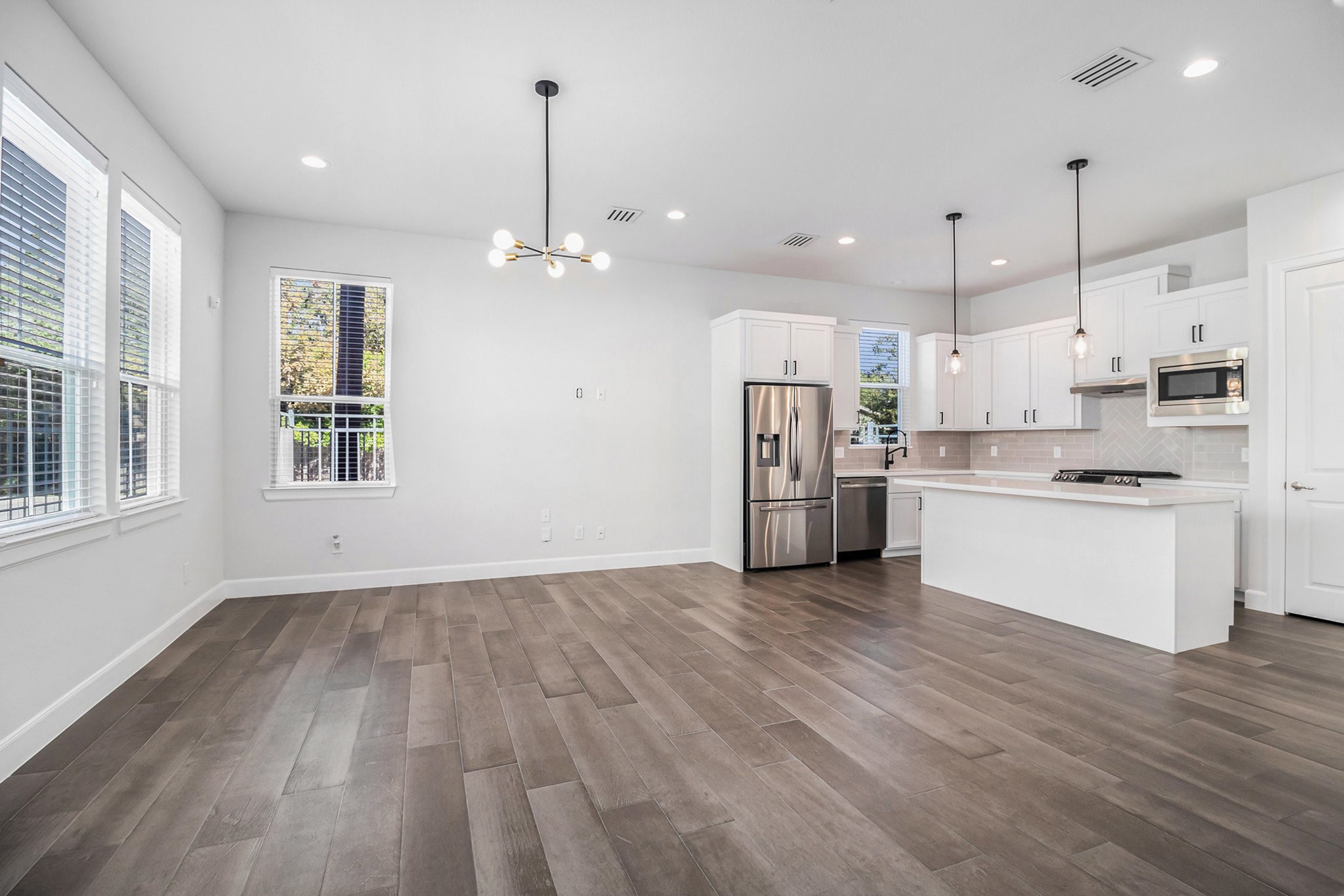 9573 Neuens Road, Unit A Houston, TX 77080 - Photo 7 of 22 a view of kitchen with granite countertop cabinets stainless steel appliances and a chandelier