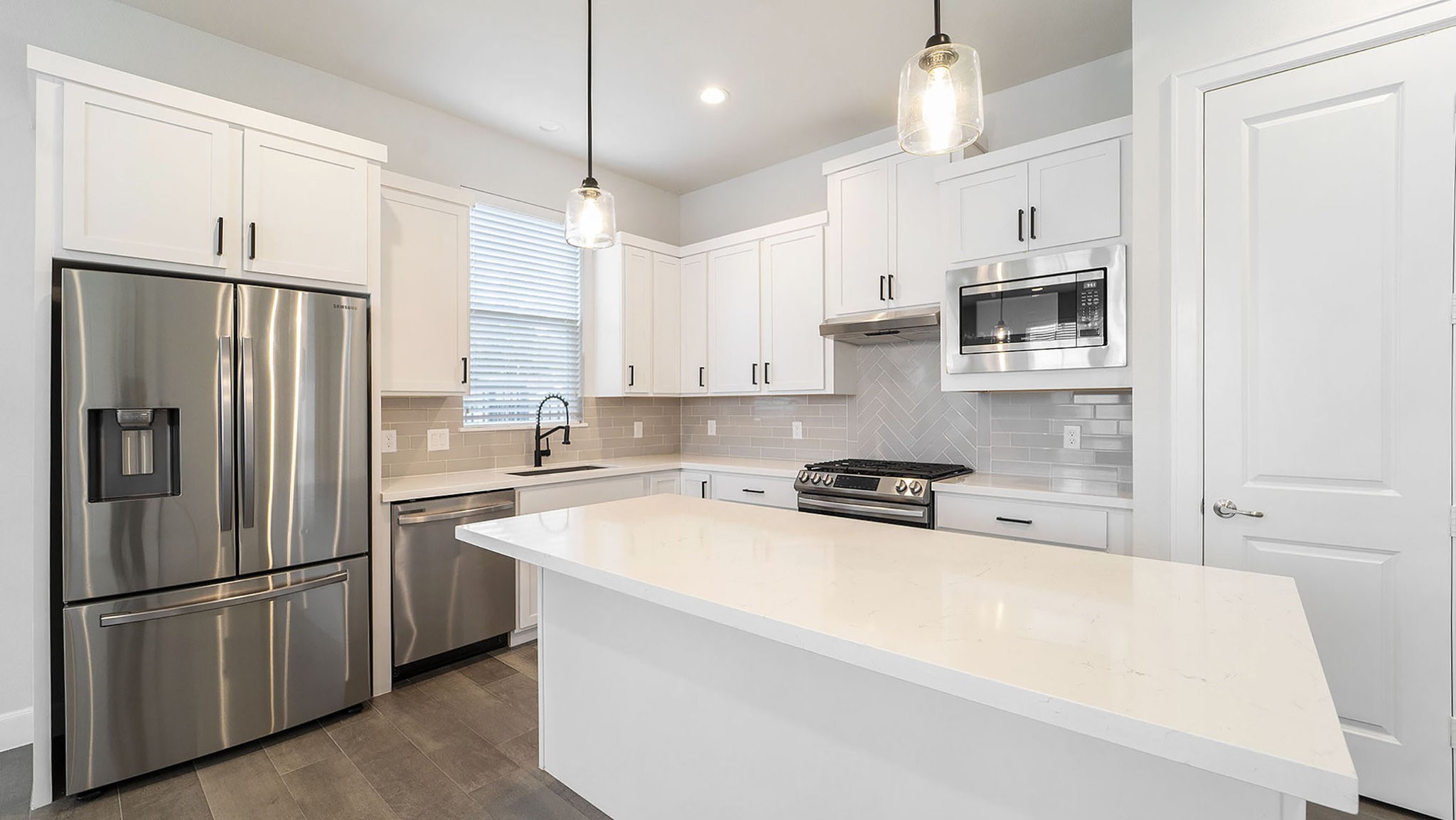 9573 Neuens Road, Unit A Houston, TX 77080 - Photo 8 of 22 a kitchen with stainless steel appliances a refrigerator sink and microwave
