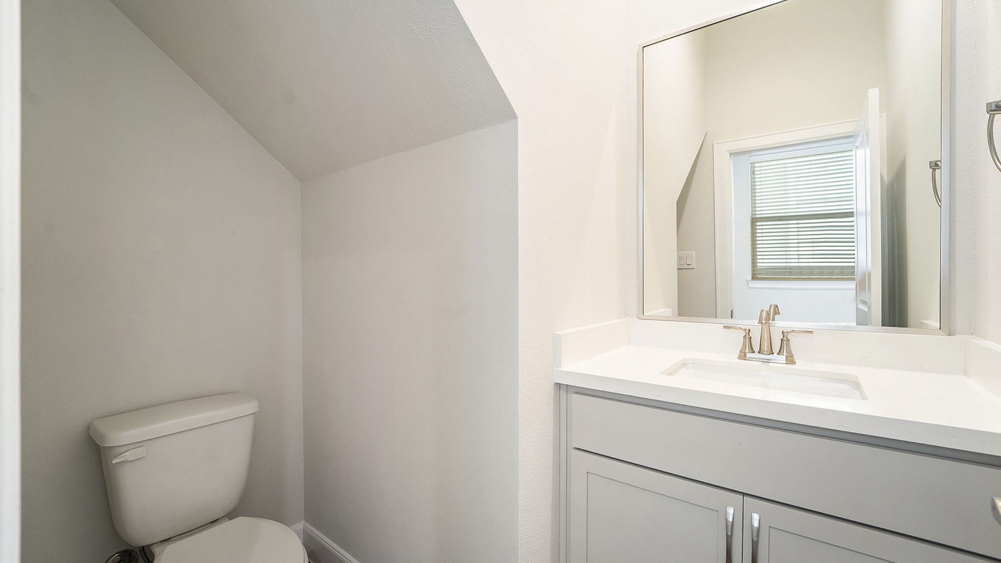 9573 Neuens Road, Unit A Houston, TX 77080 - Photo 10 of 22 a bathroom with a toilet sink and mirror