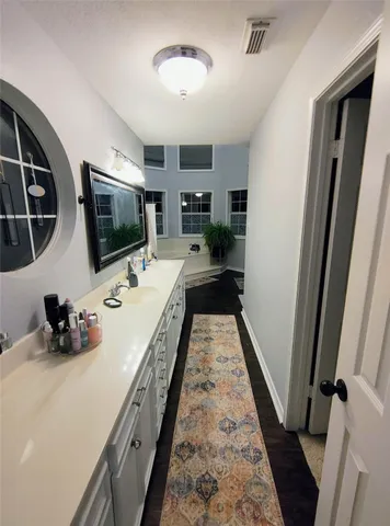 a bath room with a window and wooden floor