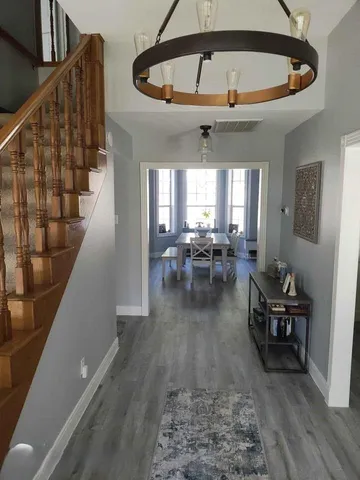 a living room with furniture and a chandelier