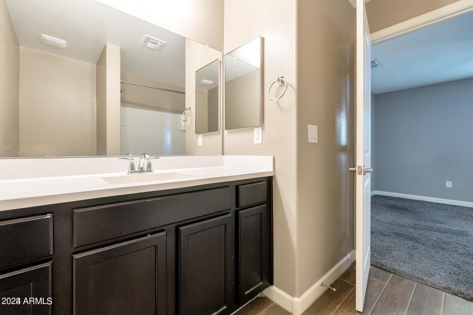 2150 West Alameda Road, Unit 1169 Phoenix, AZ 85085 - Photo 17 of 26 a bathroom with a sink and a mirror