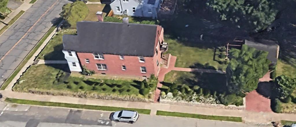 an aerial view of a house with a yard and a fountain