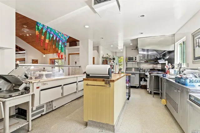 a kitchen with stainless steel appliances kitchen island granite countertop a sink and cabinets