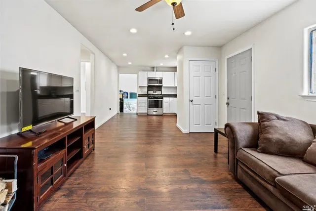 a living room with furniture and a flat screen tv