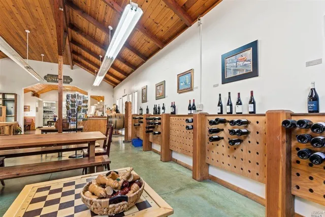 a room with lots of books and a large mirror on a table