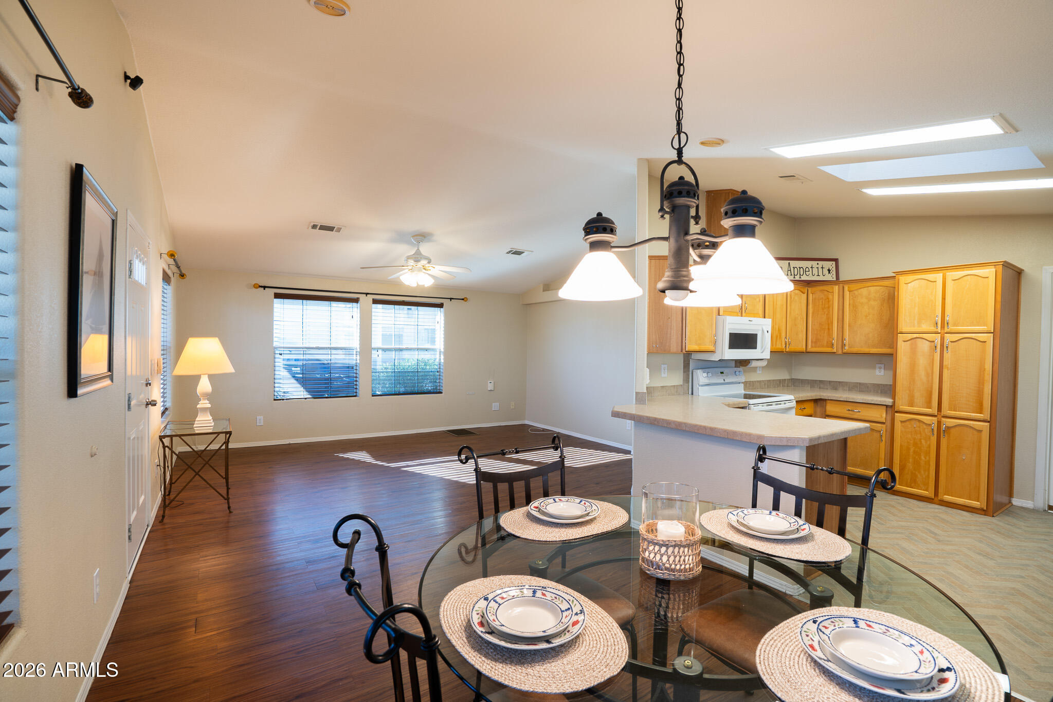 17844 North 17th Place Phoenix, AZ 85022 - Photo 5 of 22 a kitchen with a table chairs stove and wooden floor