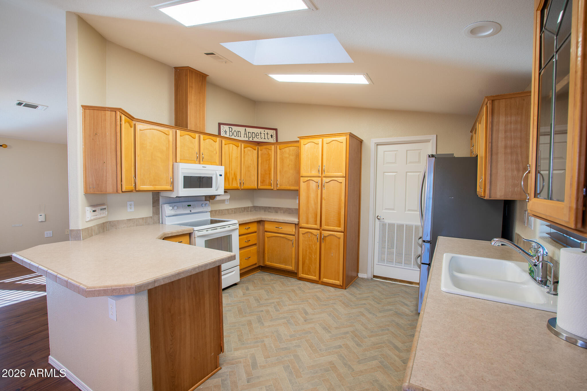17844 North 17th Place Phoenix, AZ 85022 - Photo 7 of 22 a kitchen with a refrigerator a sink and a stove