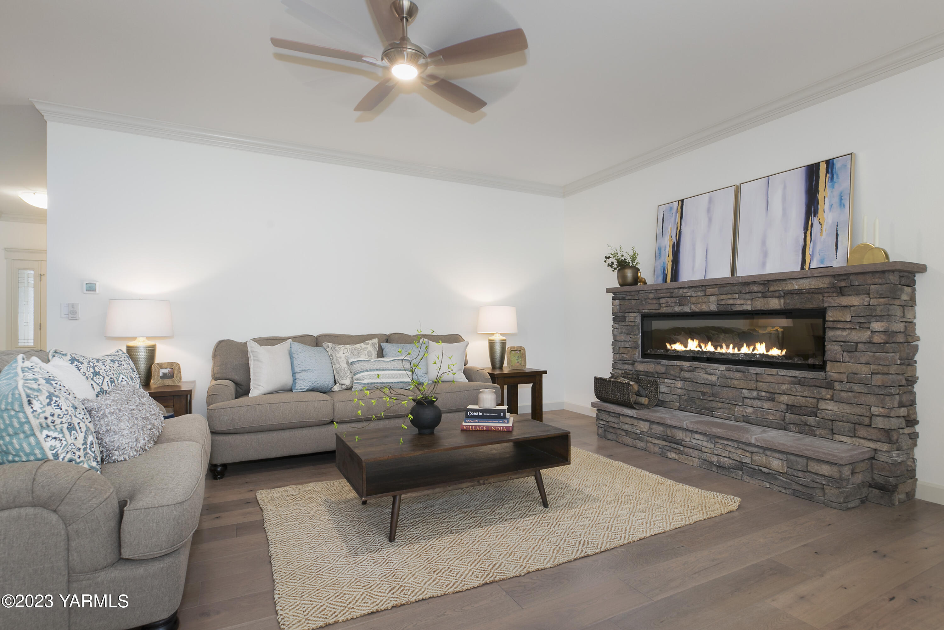 7201 Vista Ridge Avenue Yakima, WA 98903 - Photo 6 of 25 a living room with furniture a fireplace and a ceiling fan