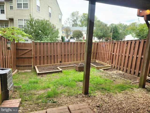 a view of a backyard with wooden fence