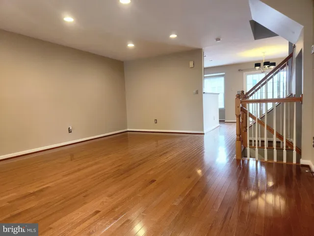 an empty room with wooden floor