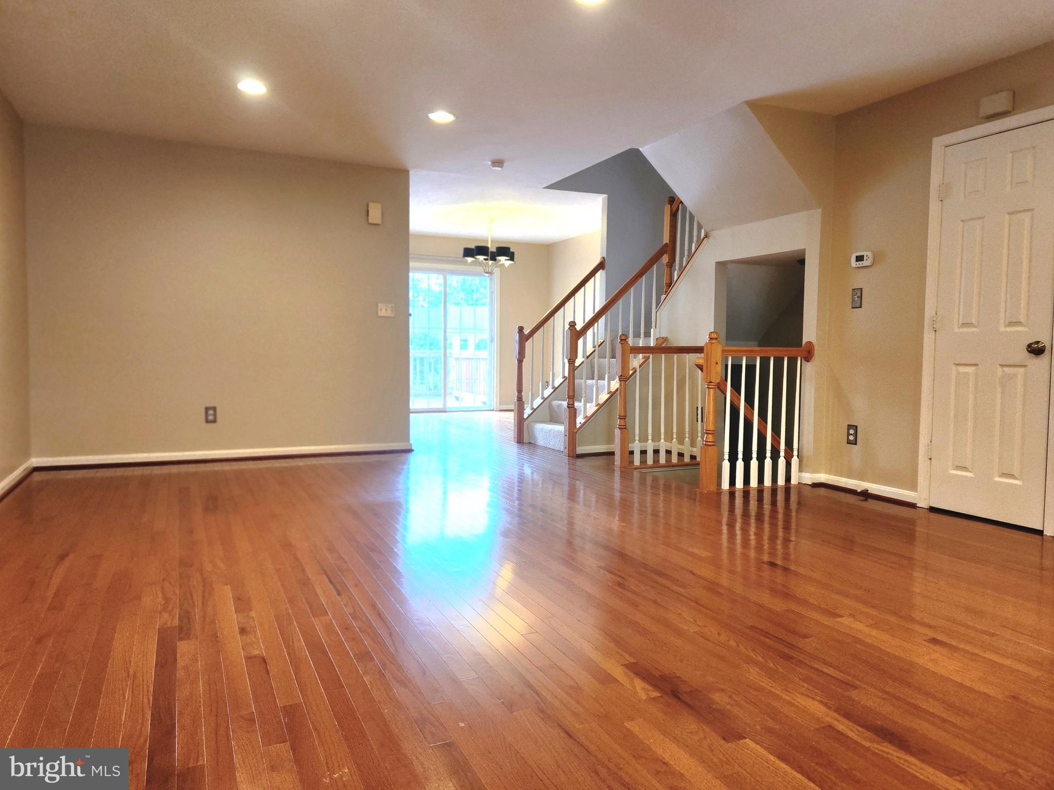 4764 Benecia Lane Dumfries, VA 22025 - Photo 3 of 17 a view of an empty room with wooden floor and stairs
