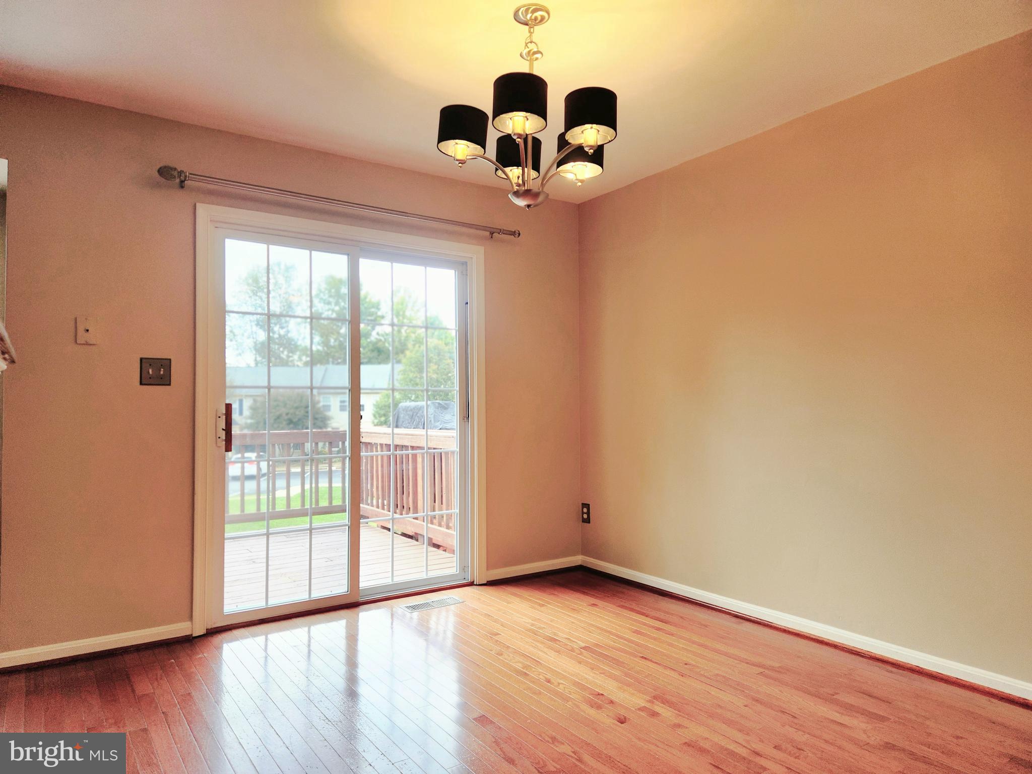 4764 Benecia Lane Dumfries, VA 22025 - Photo 5 of 17 a view of empty room with wooden floor and fan