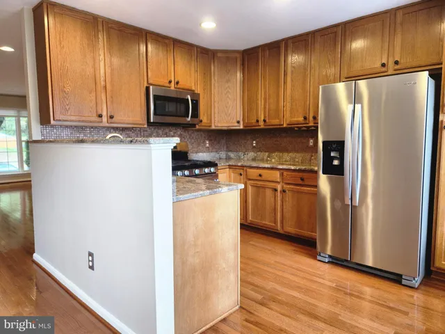 a kitchen with a refrigerator sink and microwave