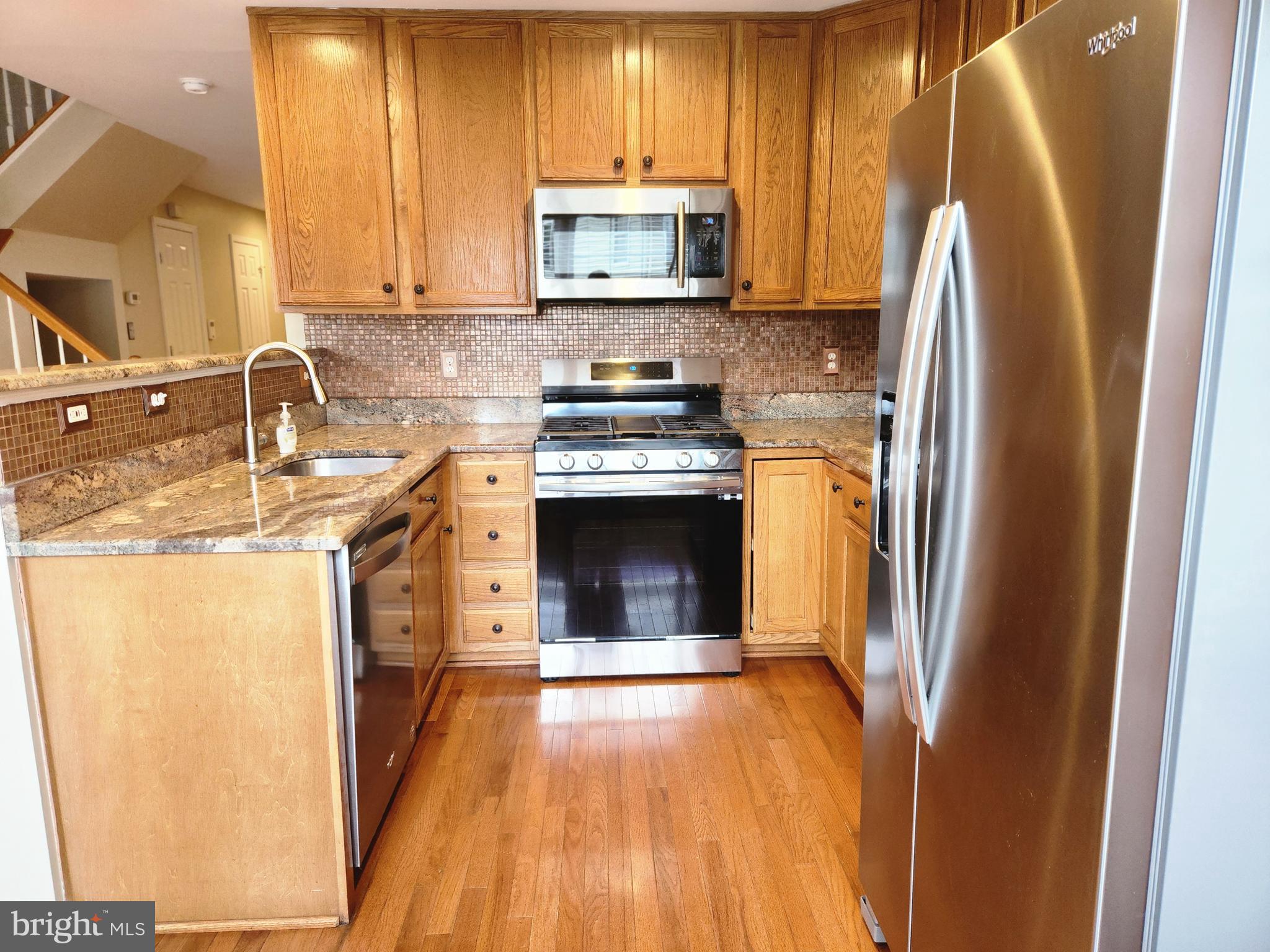4764 Benecia Lane Dumfries, VA 22025 - Photo 8 of 17 a kitchen with a sink a stove and refrigerator