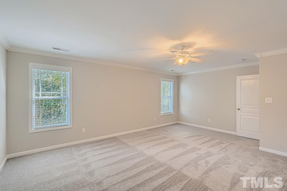 109 Oakbeech Court Holly Springs, NC 27540 - Photo 12 of 28 wooden floor in an empty room with a window