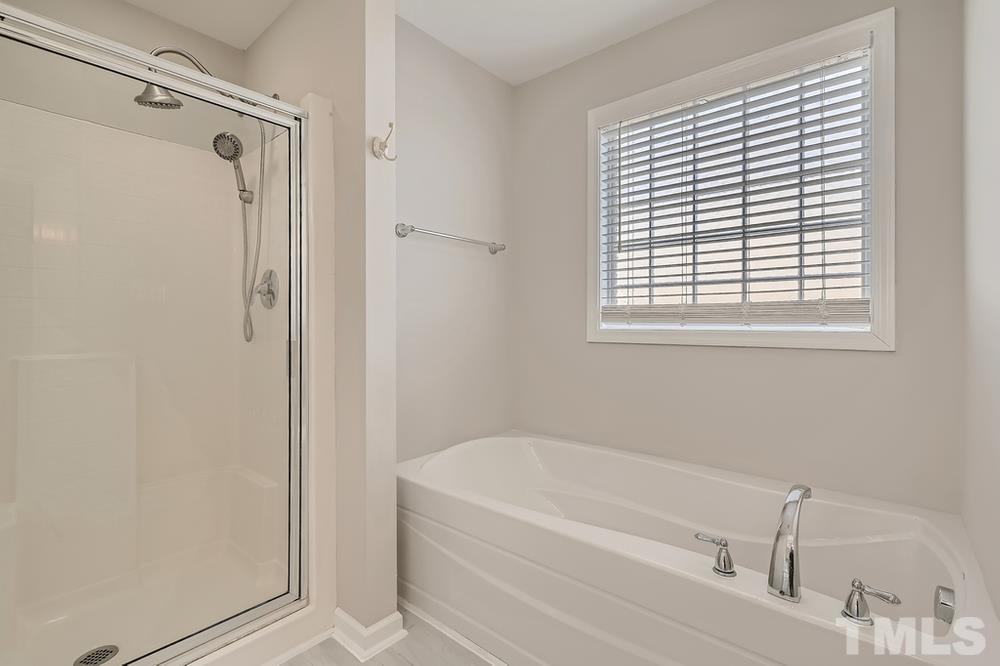 109 Oakbeech Court Holly Springs, NC 27540 - Photo 15 of 28 a white bath tub sitting next to a window