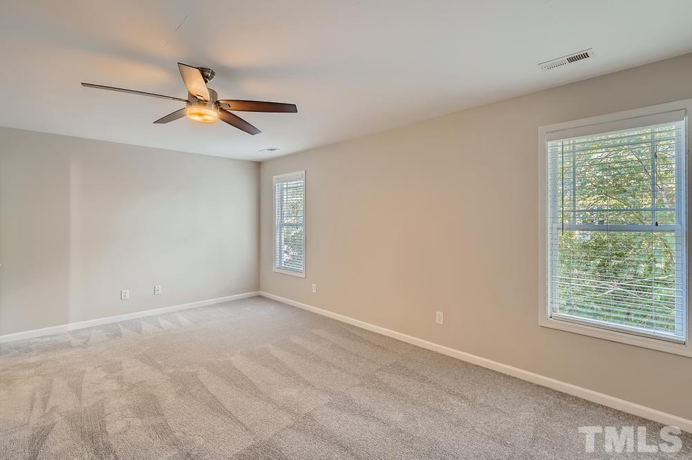109 Oakbeech Court Holly Springs, NC 27540 - Photo 20 of 28 an empty room with windows and fan