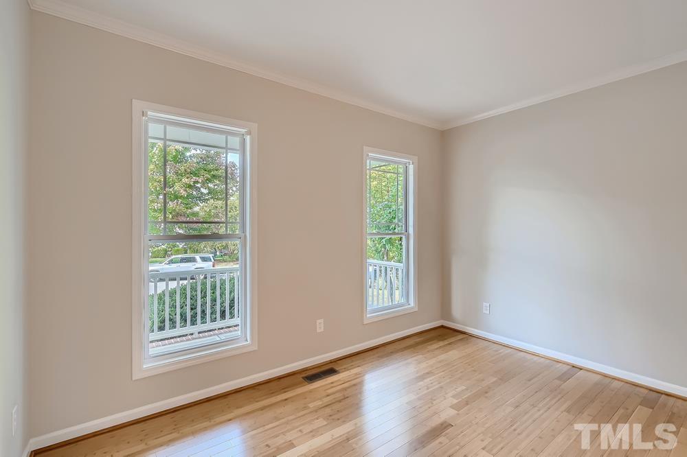 109 Oakbeech Court Holly Springs, NC 27540 - Photo 22 of 28 an empty room with wooden floor and windows