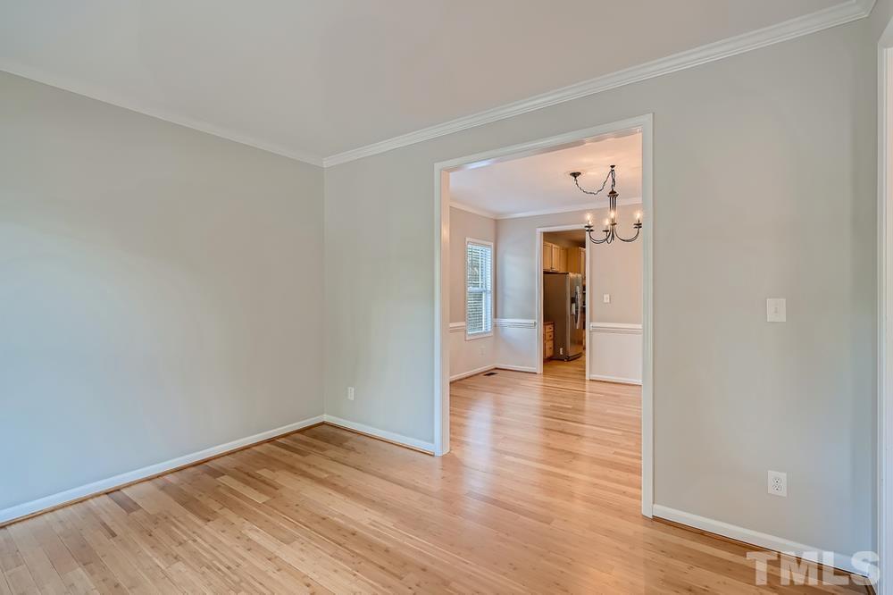 109 Oakbeech Court Holly Springs, NC 27540 - Photo 23 of 28 a view of a hallway with wooden floor
