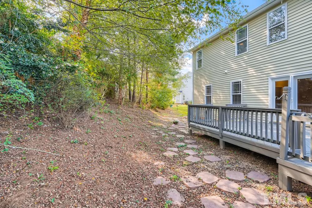 109 Oakbeech Court Holly Springs, NC 27540 - Photo 26 of 28 a view of a backyard with large trees and wooden fence