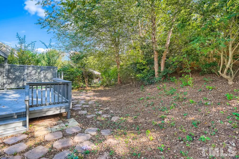 109 Oakbeech Court Holly Springs, NC 27540 - Photo 27 of 28 a view of backyard with wooden fence and trees