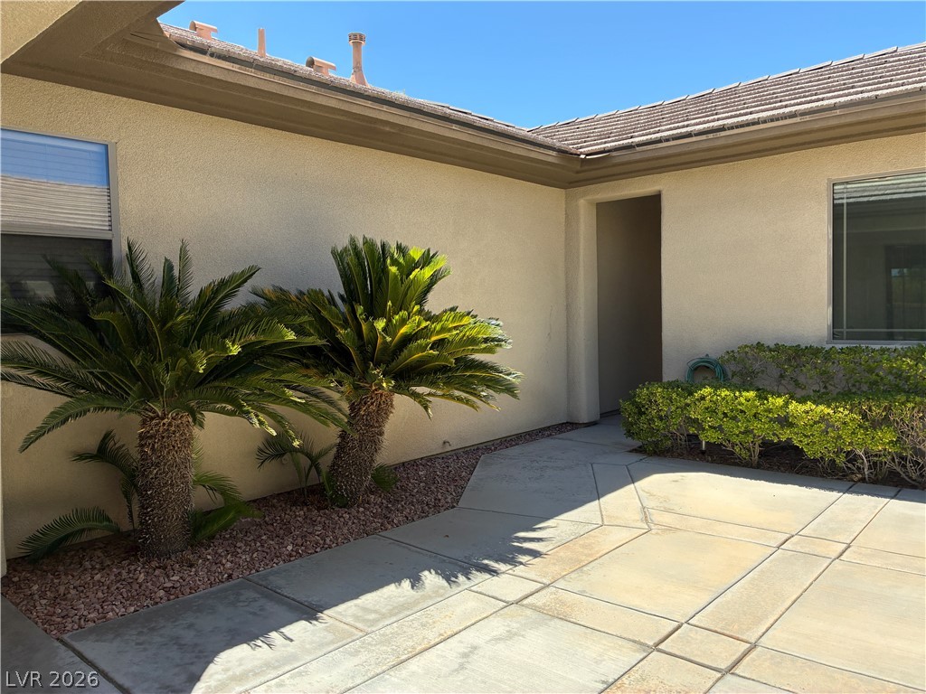 10 Caprington Road Henderson, NV 89052 - Photo 44 of 44 A welcoming front entrance featuring desert landscaping and a tiled roof.