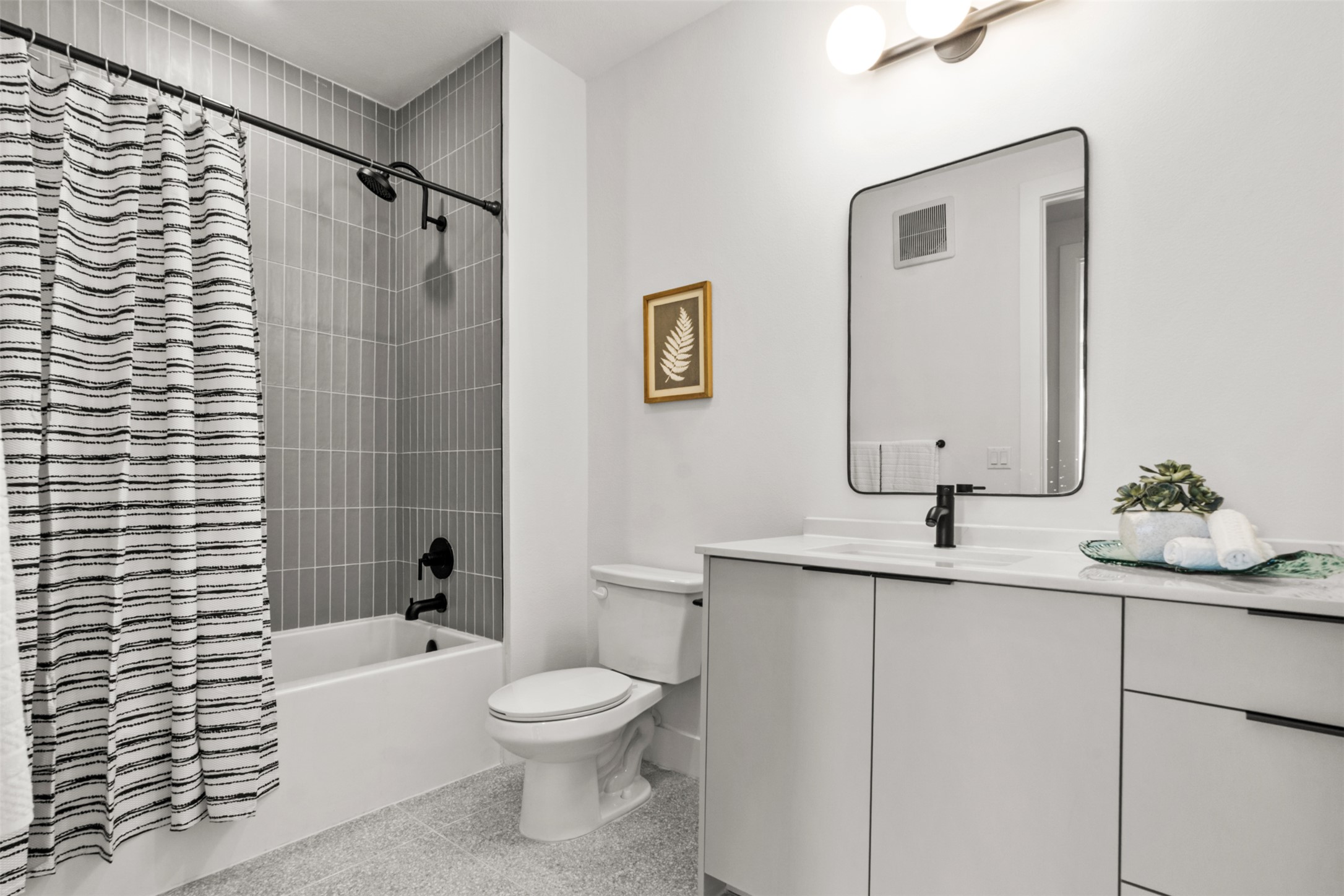 1701 Simond Avenue, Unit 418 Austin, TX 78723 - Photo 22 of 37 Full bath featuring vanity, shower / bath combo with shower curtain, visible vents, and toilet