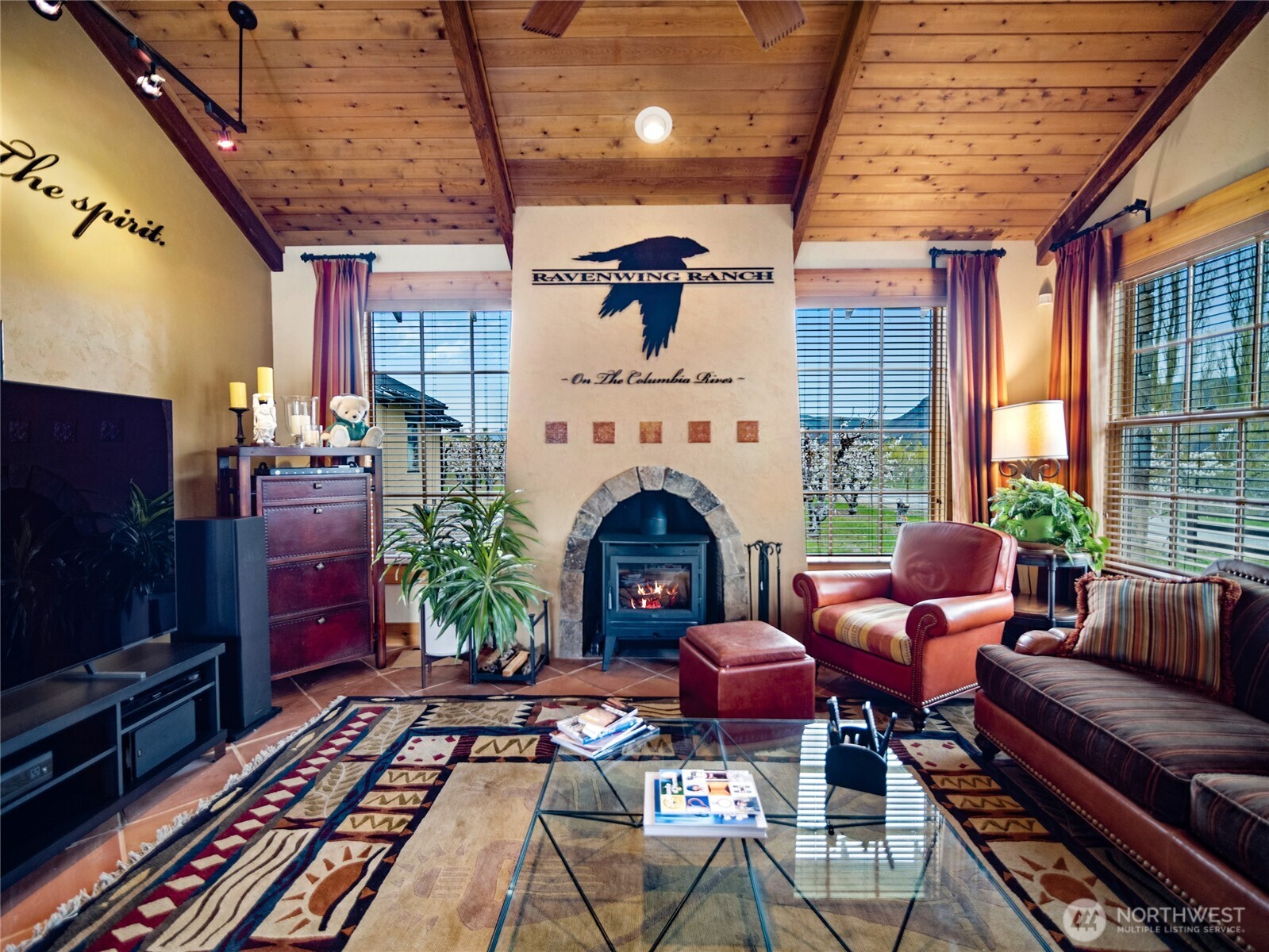 5814 Colockum Road Malaga, WA 98828 - Photo 6 of 40 a living room with furniture a fireplace and a flat screen tv