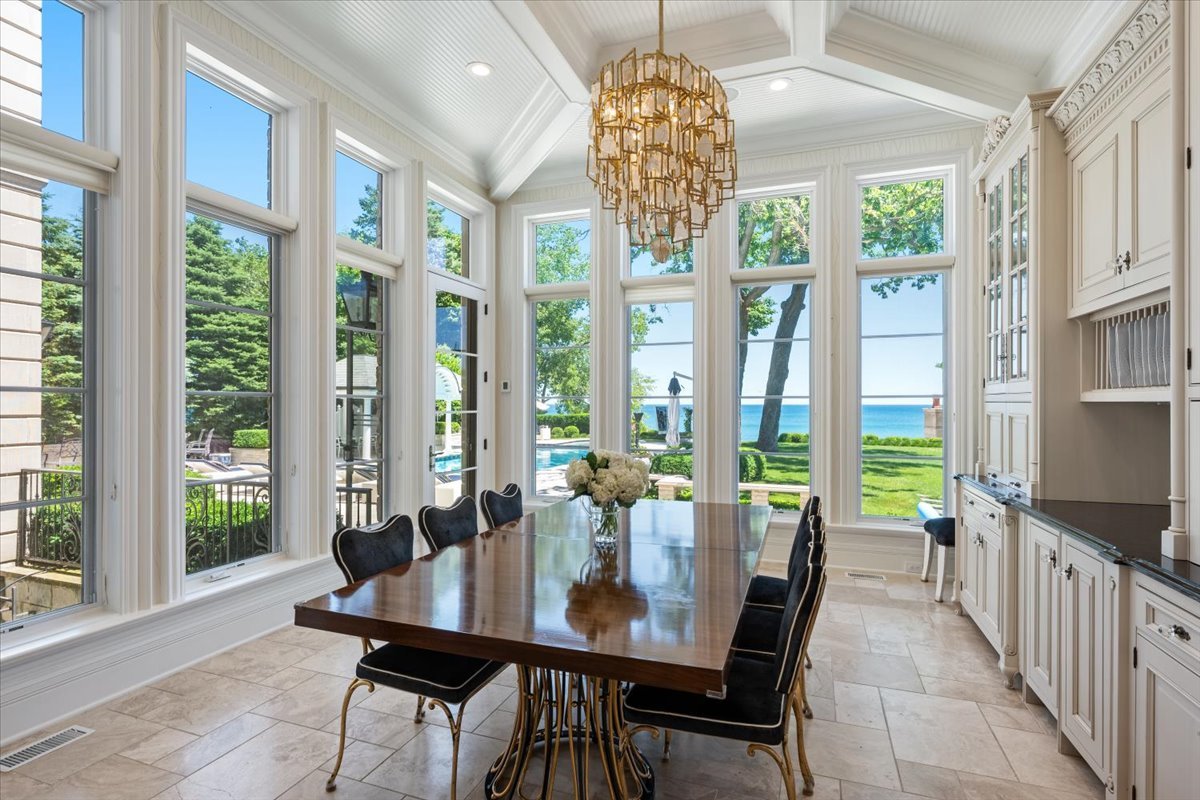 319 Sheridan Road Winnetka, IL 60093 - Photo 23 of 81 a view of a dining room with furniture large windows and wooden floor