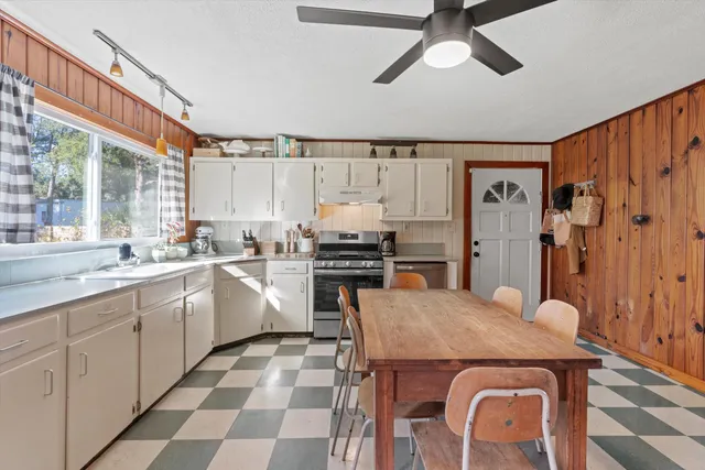 a kitchen with a stove a sink and a refrigerator
