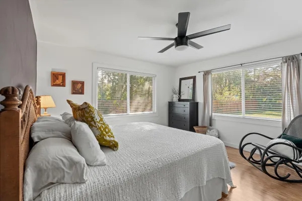 a bed sitting in a bedroom next to a window