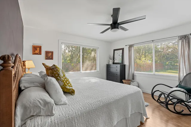 a bed sitting in a bedroom next to a window