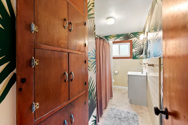 a bathroom with a shower and a sink