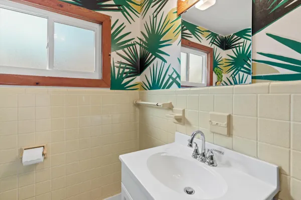 a bathroom with a sink a mirror and a bathtub