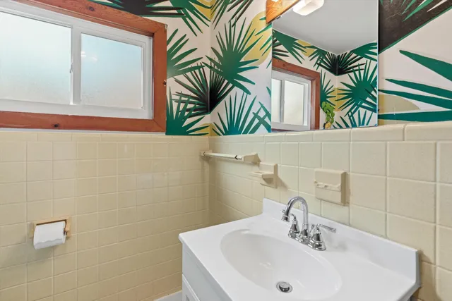 a bathroom with a sink a mirror and a bathtub