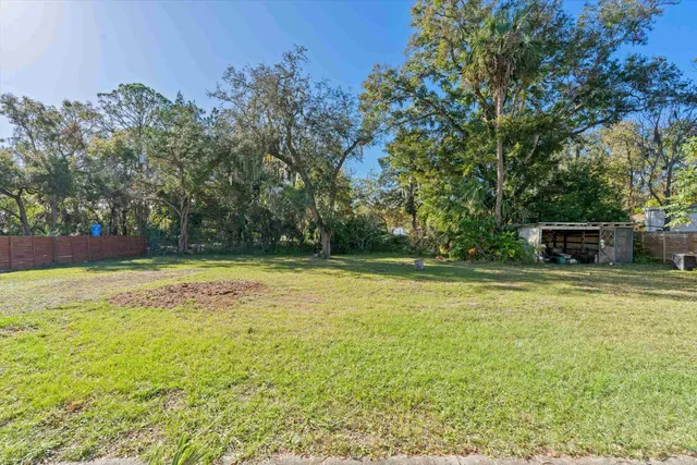 a view of a swimming pool with a yard
