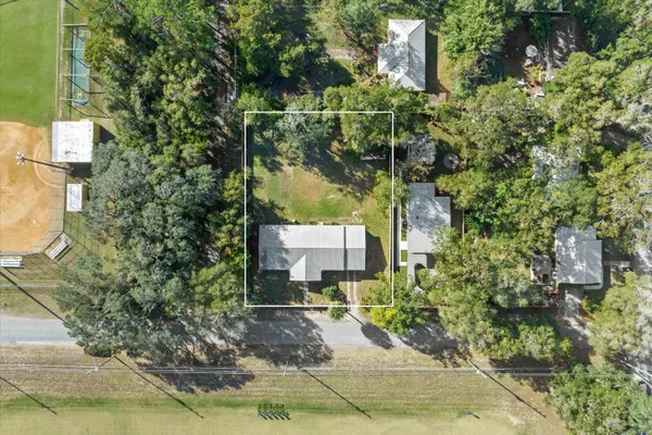a sign board with buildings in the background