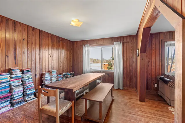 a view of a dining room with furniture and window