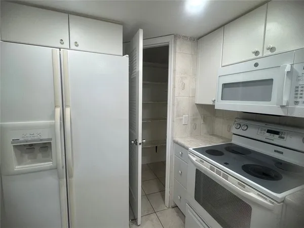 a kitchen with cabinets appliances and a sink