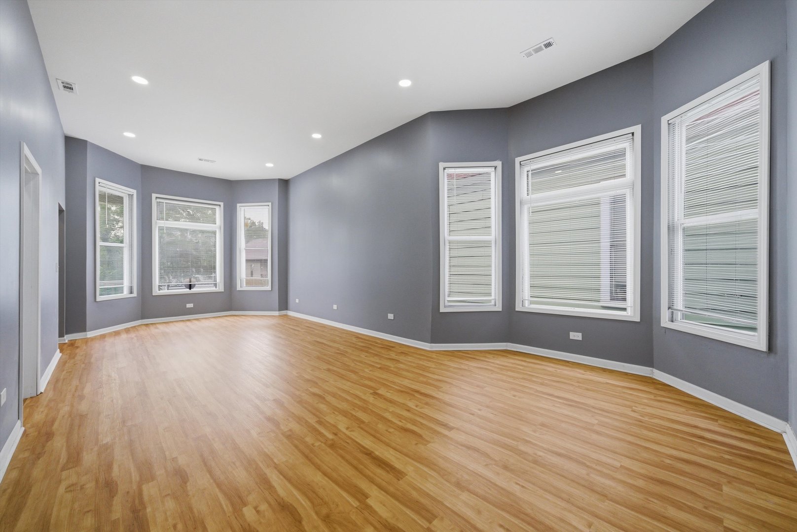 7828 South Escanaba Avenue Chicago, IL 60649 - Photo 7 of 41 a view of an empty room with wooden floor and a window