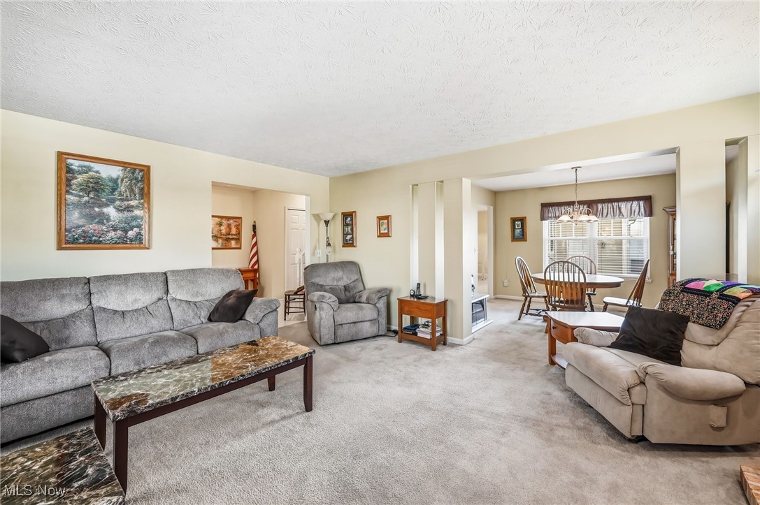4420 Archer Road Cleveland, OH 44105 - Photo 2 of 18 Living room with carpet flooring, beautiful fireplace and a textured ceiling